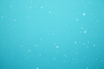 Blue bokeh background with snow. Empty winter background, snowy, festive