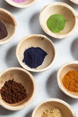 Set of natural pigment powder from herbs in small bowls. Dye from nature.