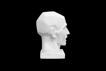 angular plaster man head isolated on black background. profile view