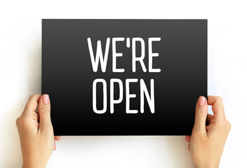 We're Open text on card, concept background
