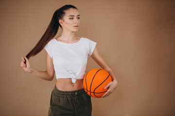 Young woman basketball player isolated at studio