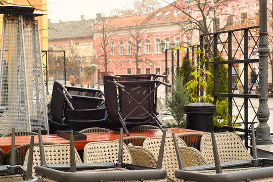 Facade of old historic buildings and empty open air terrace of cafe in the pedestrian center of tourist city Novi Sad, Serbia
