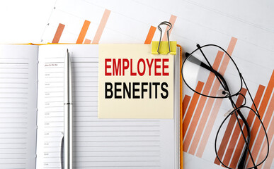 Text EMPLOYEE BENEFITS on sticker on the notepad on diagram background