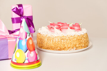 Festive beautiful cake decorated with roses flowers on the table on a light background