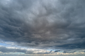 Aerial view from high altitude of earth covered with puffy rainy clouds forming before rainstorm