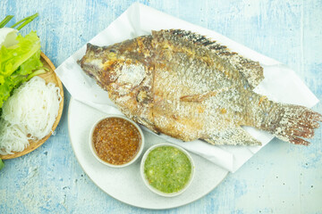 Grilled tilapia served with Chinese noodle, fresh vegetable and spicy sauce and sweet and spicy dip