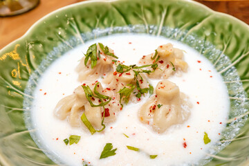 A traditional dish of Georgian cuisine is khinkali with broth in matsoni sauce