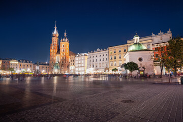 Fototapeta na wymiar Main Market Square at night with St. Mary's Basilica and Church of St. Wojciech - Krakow, Poland
