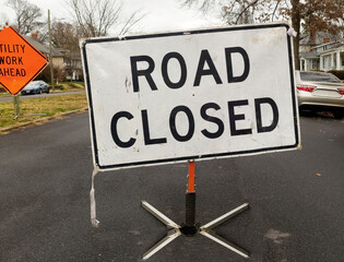 ROAD CLOSED sign in middle of neighborhood street.