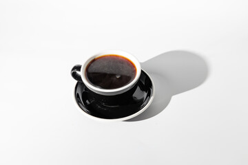 Top view of coffee in black cup with sauce