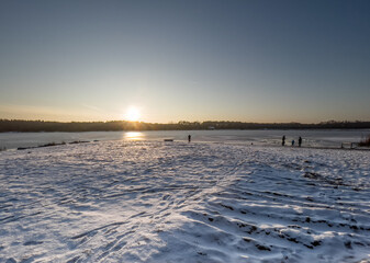 Winter family walks to the frozen lake