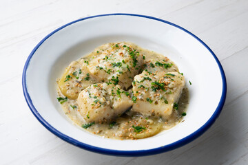 Cod in green sauce with potatoes. Traditional northern Spanish tapa