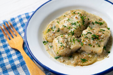 Cod in green sauce with potatoes. Traditional northern Spanish tapa