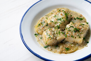 Cod in green sauce with potatoes. Traditional northern Spanish tapa