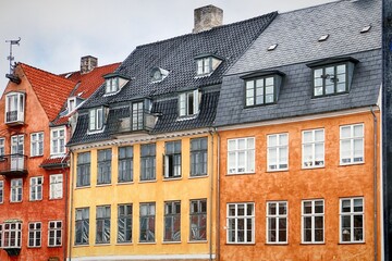 COPENHAGEN, DENMARK - Colorful houses parade at Nyhavn harbor famous landmark of Copenhagen  built in 17th-century and now entertainment district