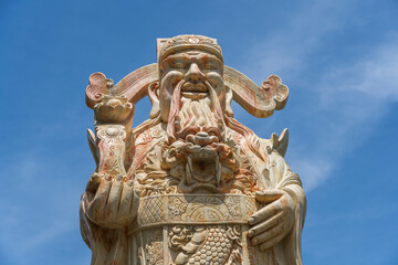 Fototapeta na wymiar Face of an ancient Chinese warrior statue or god Chinese in a Buddhist temple in the city of Danang, Vietnam
