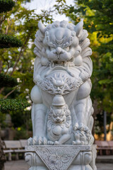 Marble white lion statue in outdoors park, Vietnam. Close up