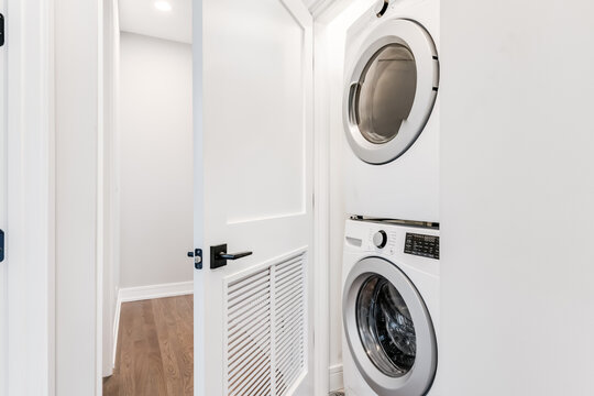 White Stackable Washer And Dryer In Closet