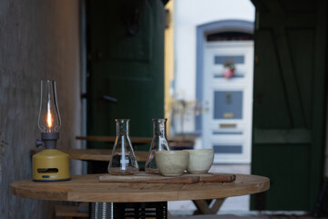 Slow travel Denmark: Restaurant tables with bowls and bottles in an open backyard in Ribe