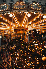 Magic golden retro children's magic carousel with horses Merry-go-round in the fairy garland bokeh...