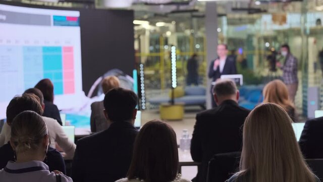 People gathering in modern hall during business forum