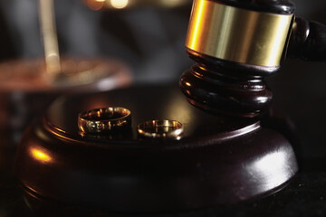 Divorce concept. Judge gavel and wedding rings. Top view