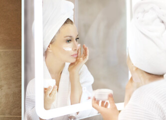 Magic anti-aging cream.Applying the cream.