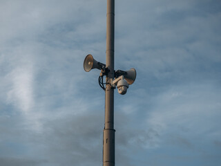 Everything's under control. Viewing black cameras on a column in a public place. Copy space, black speaker and black cameras on the black post.