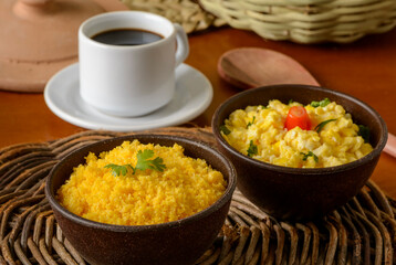 Food from the northeast of Brazil. Corn couscous with egg in clay bowl.