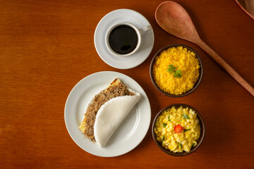 Fototapeta na wymiar Sun meat tapioca and curd cheese, with eggs and couscous. Typical Brazilian Northeast breakfast.