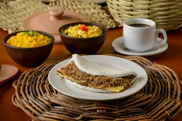 Sun meat tapioca and curd cheese, with eggs and couscous. Typical Brazilian Northeast breakfast.