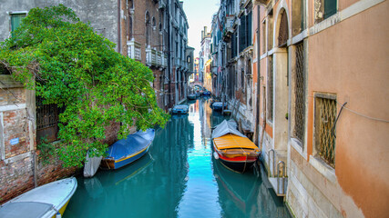 Fototapeta na wymiar A small canal in Venice with beautiful colorful houses, Italy. Venice is a city in northeastern Italy and the capital of the Veneto region.