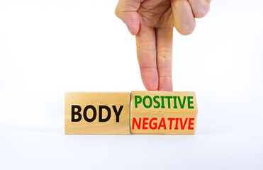 Body positive or negative symbol. Psychologist turns cubes, changes words body negative to body positive. Beautiful white background, copy space. Psychological, body positive or negative concept.