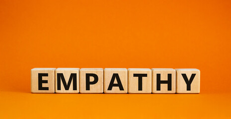 Empathy symbol. The concept word Empathy on wooden cubes. Beautiful orange table, orange...