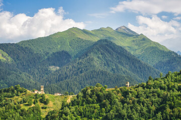 Ushguli village with rock tower houses in Svaneti, Georgia with a view of Greater Caucasus mountains. These are typical Svaneti defensive tower houses found throughout the village