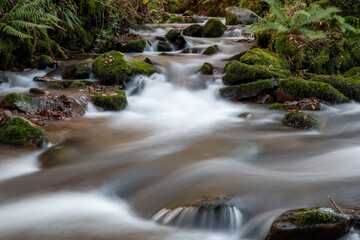 Fototapeta na wymiar Long exposure of a waterfall on the river Horner in Horner woods in Somerset