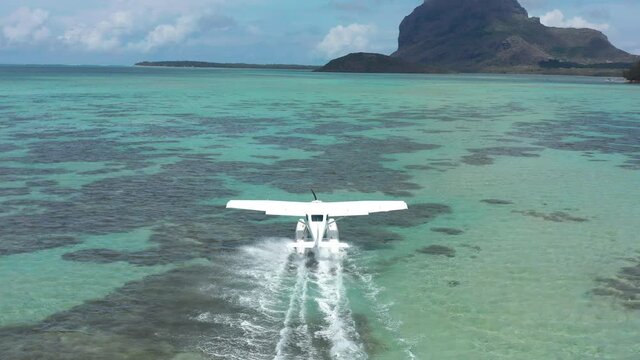 Aerial view. White hydroplane takeoff in a calm lagoon