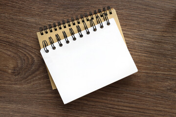 two blank spiral notebooks on wooden table for blank mockup template