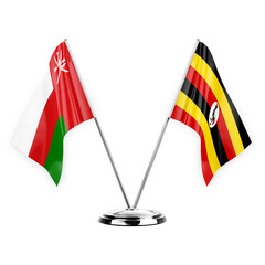 Two table flags isolated on white background 3d illustration, oman and uganda