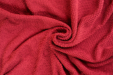 a red towel wrapped in a spiral