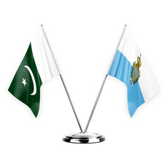 Two table flags isolated on white background 3d illustration, pakistan and san marino