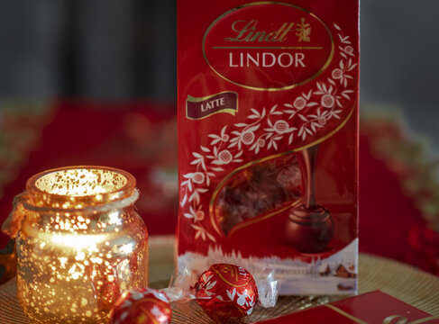 Lindt, milk chocolate balls with red festive livery.Milan - Italy, December 29th 2021