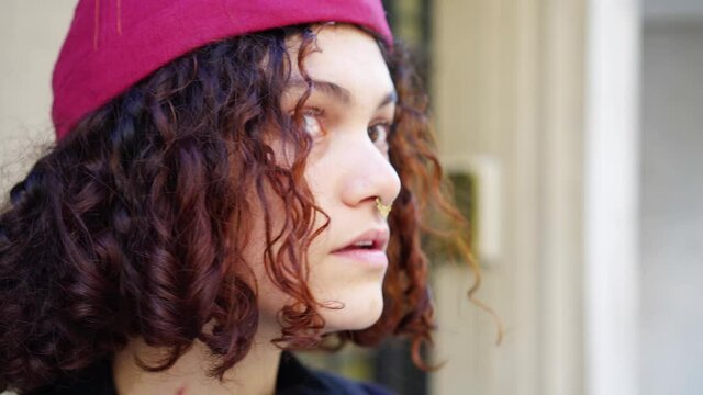 young latina hipster woman, close up in the face, looking hesitantly to the sides until a decision is made, 4k video