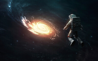 Fototapeta na wymiar Astronaut at spacewalk looks at Milky Way galaxy. Elements of image provided by Nasa