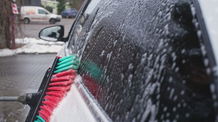Cleaning and Washing Car Side Windows Using Shampoo Soap Flowing Out from Nylon Fibre Brush...