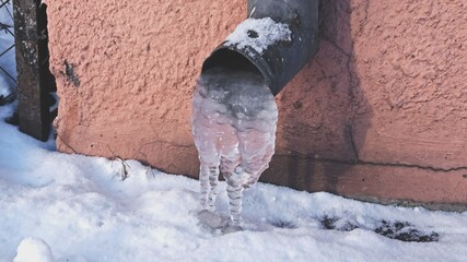 Metal Rain Gutter Blocked with Frozen Water Icicles on Cold Winter Morning	 - obrazy, fototapety, plakaty