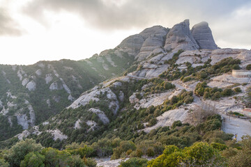 Obraz premium Picturesque landscape with mountains. Landscape and beautiful sunset on Montserrat mountain. Rock formations and cliffs in the Catalan Natural Park of Montserrat. Barcelona, Catalonia, Spain