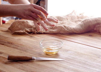 person breaking  eggs to make muffin dough at home