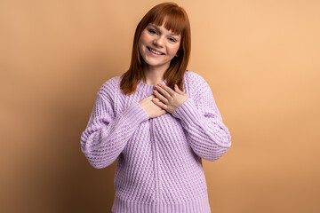 Beautiful positive friendly-looking young woman with lovely sincere smile feeling thankful