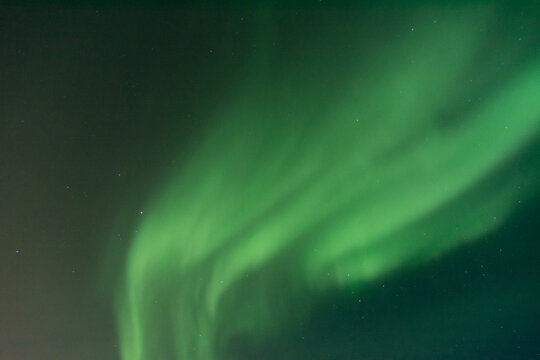 A photo of the night sky filled completely with the northern lights or aurora borealis near Churchill, Manitoba, Canada